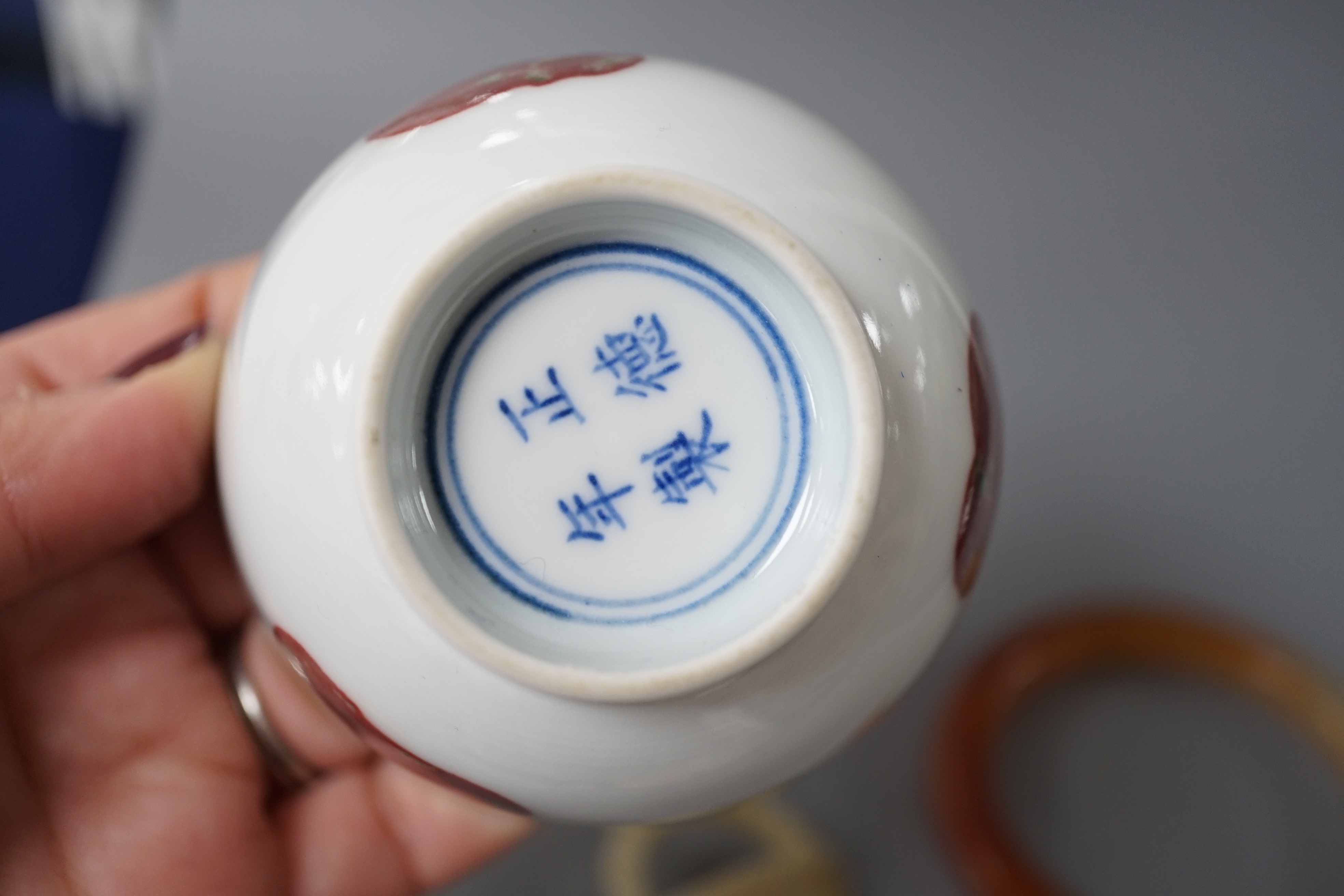 A Chinese porcelain teabowl with ‘fruit’ decoration, an agate bangle and a similar ‘basket’ carving.